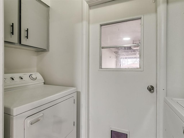 laundry area with cabinets and independent washer and dryer