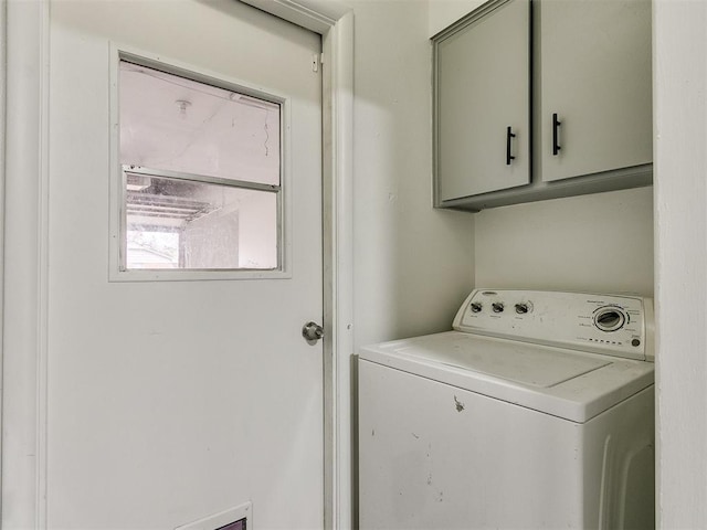 washroom with cabinets and washer / dryer