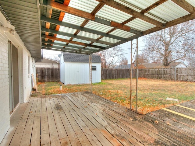 wooden terrace with a yard and a shed