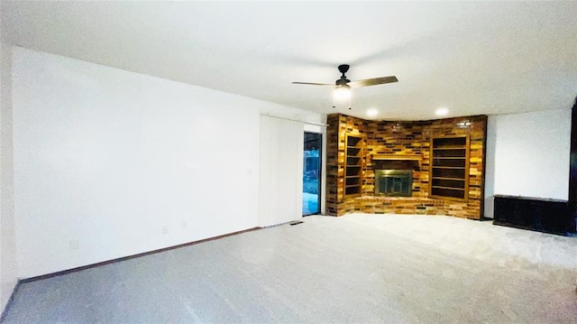 unfurnished living room featuring carpet flooring, a fireplace, and ceiling fan