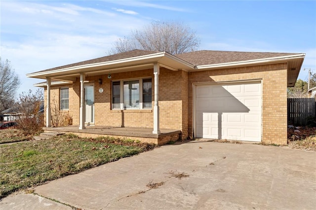 ranch-style home with covered porch and a garage