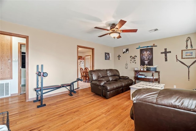 living room featuring light wood-type flooring and ceiling fan