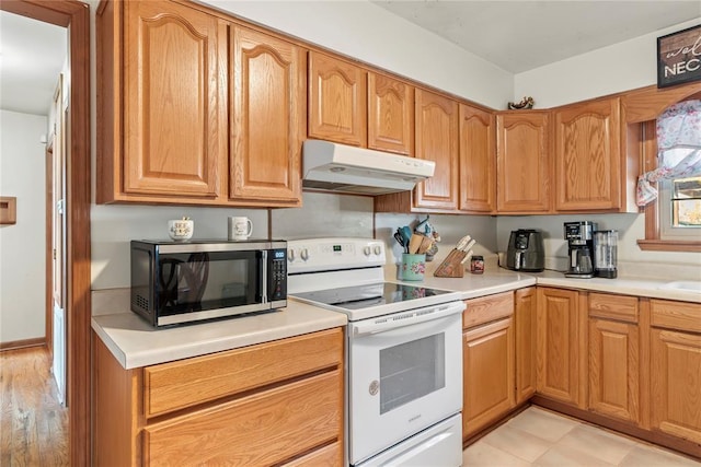 kitchen with white electric range oven and light hardwood / wood-style floors