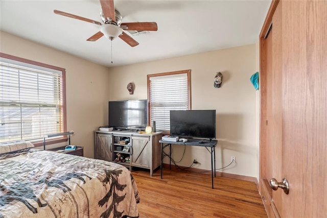 bedroom with ceiling fan and light wood-type flooring