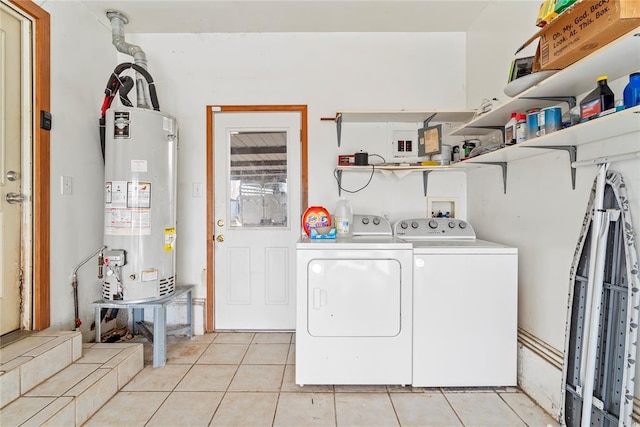 laundry room with washing machine and clothes dryer, light tile patterned flooring, and gas water heater