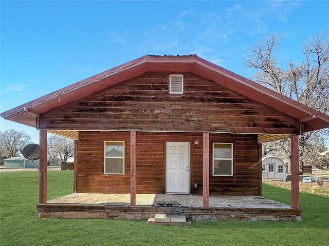 rear view of property with a patio area and a yard