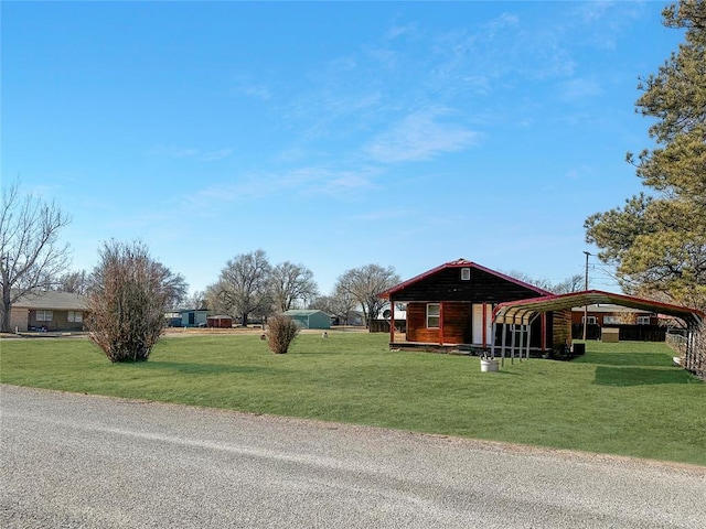 exterior space featuring a carport and a lawn