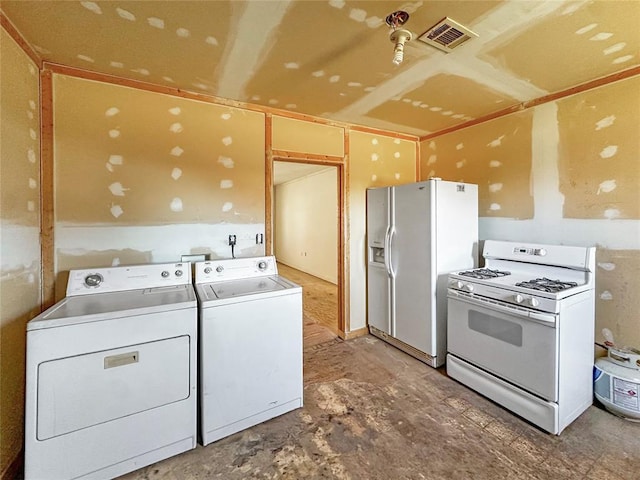 interior space featuring washing machine and dryer, white cabinetry, and white appliances