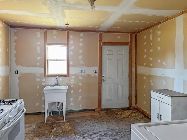 kitchen with white stove and white cabinetry