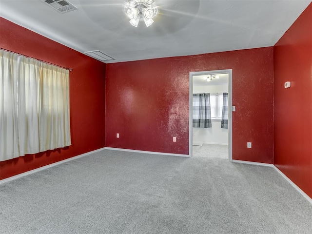 carpeted empty room with ceiling fan