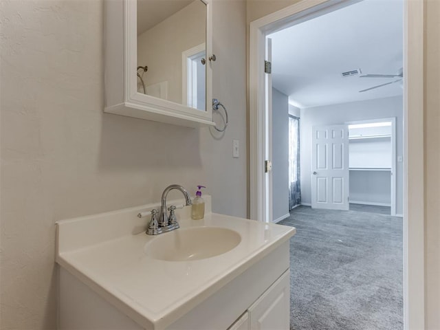 bathroom with ceiling fan and vanity