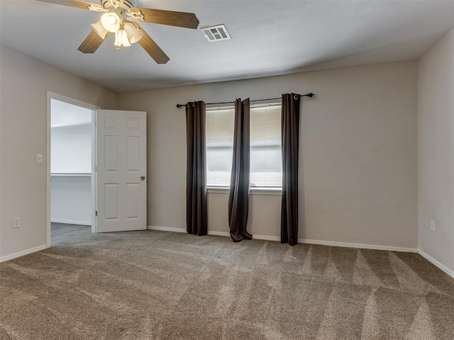 empty room featuring carpet flooring and ceiling fan