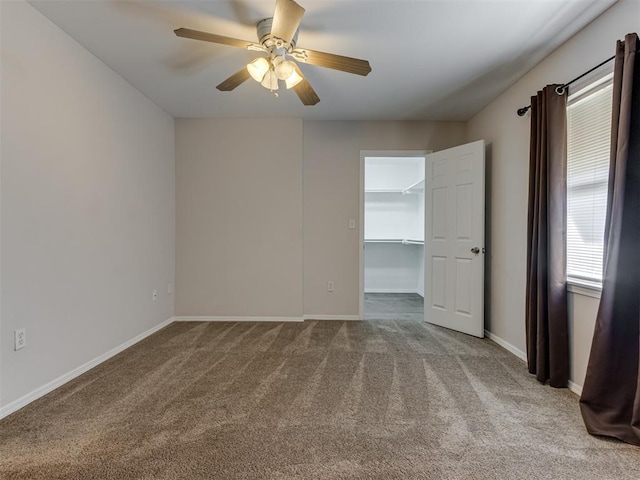 empty room with ceiling fan and light colored carpet