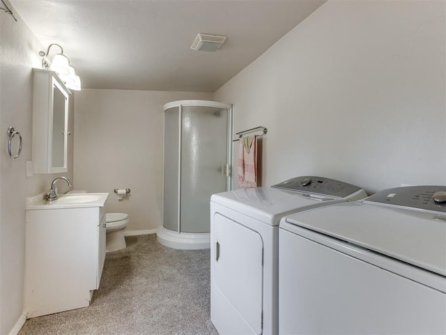 laundry area with light colored carpet, sink, and washing machine and clothes dryer