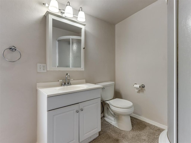 bathroom featuring vanity, toilet, and walk in shower