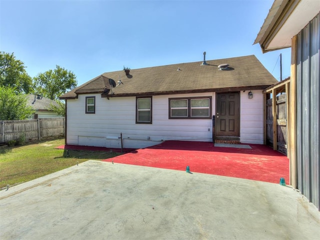 back of house featuring a lawn and a patio area