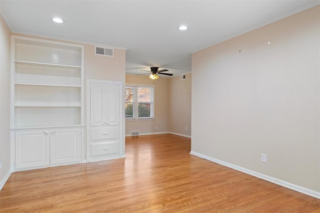 unfurnished room with light hardwood / wood-style floors, ceiling fan, and crown molding