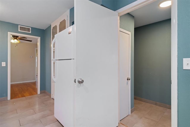 kitchen featuring white cabinets, ceiling fan, white refrigerator, and light hardwood / wood-style flooring