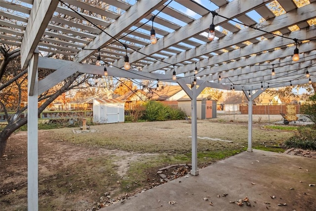 view of yard with a patio, a storage unit, and a pergola