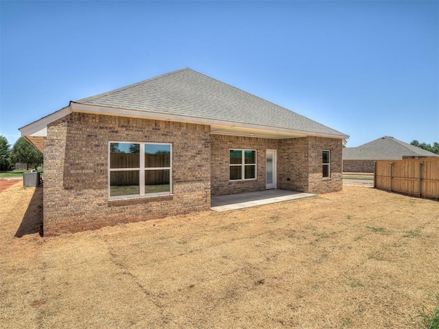 back of property featuring central AC unit and a patio