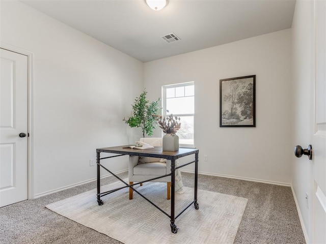 office space with light colored carpet, visible vents, and baseboards