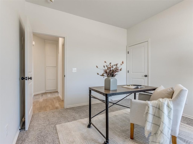 office featuring light colored carpet and baseboards