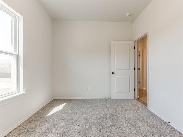 empty room with carpet floors and baseboards