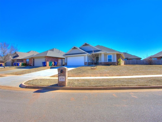 view of front of property featuring an attached garage, fence, concrete driveway, board and batten siding, and a front yard