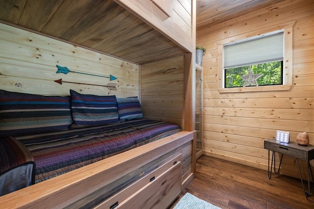 bedroom featuring wood walls, dark hardwood / wood-style flooring, and wood ceiling