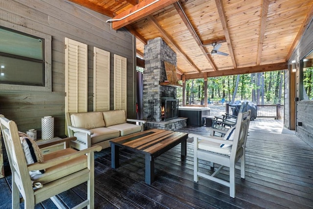 wooden deck with an outdoor living space with a fireplace and area for grilling