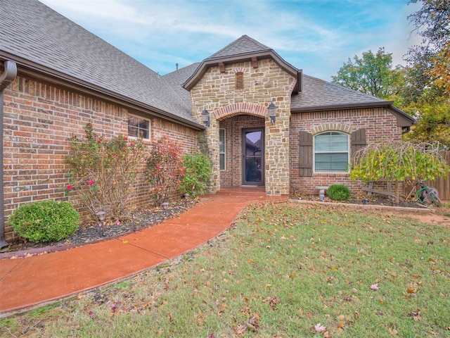 entrance to property with a lawn