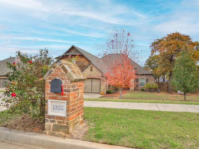 view of front of home featuring a front lawn and a garage