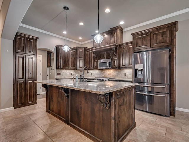 kitchen featuring dark brown cabinetry, hanging light fixtures, light stone counters, a kitchen bar, and appliances with stainless steel finishes