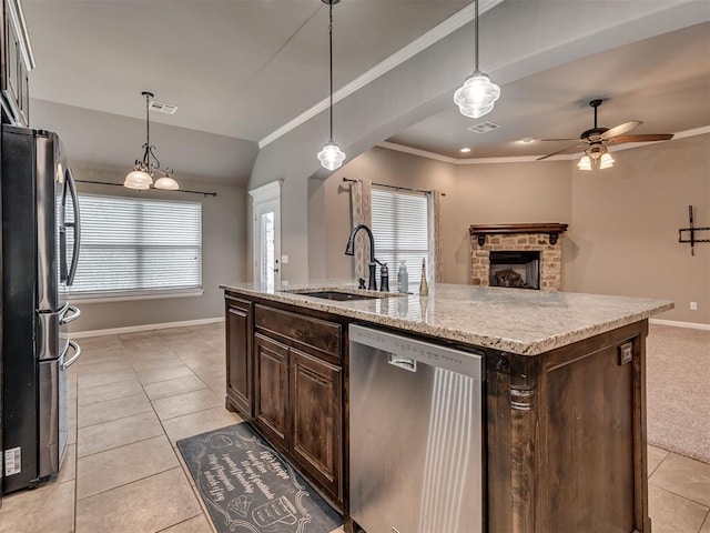 kitchen featuring sink, an island with sink, pendant lighting, dark brown cabinets, and appliances with stainless steel finishes