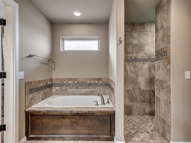 bathroom featuring plus walk in shower