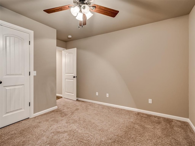 unfurnished bedroom with ceiling fan and light carpet