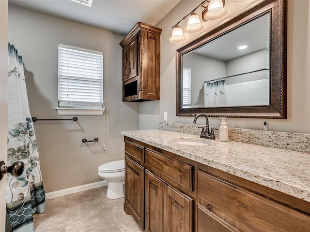 bathroom with walk in shower, vanity, and toilet