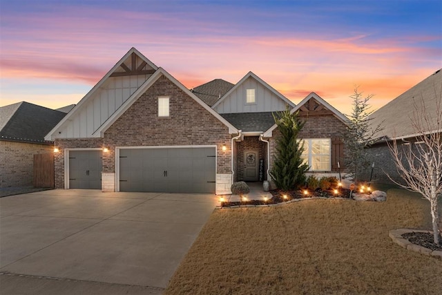 craftsman inspired home featuring brick siding, board and batten siding, a shingled roof, concrete driveway, and an attached garage