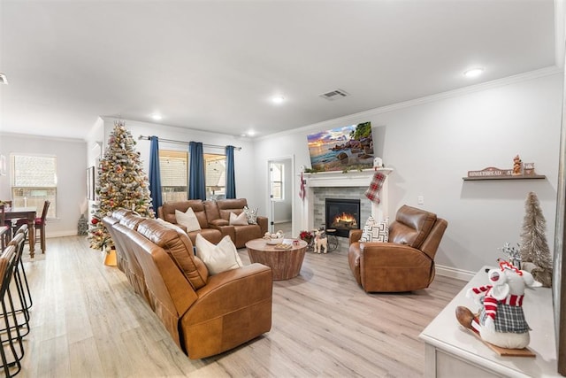 living room with light hardwood / wood-style floors and ornamental molding