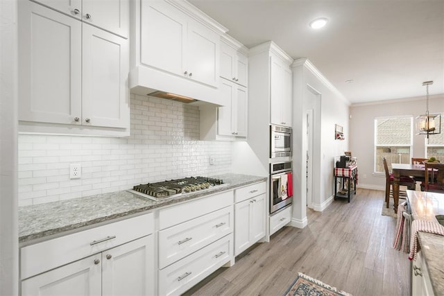 kitchen with white cabinetry, light hardwood / wood-style flooring, crown molding, decorative backsplash, and appliances with stainless steel finishes