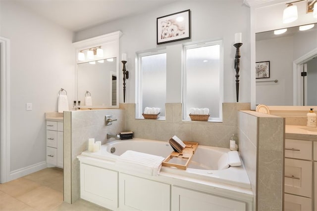 bathroom with tile patterned flooring, a bath, and vanity