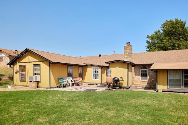 rear view of house with a lawn, a patio area, and cooling unit