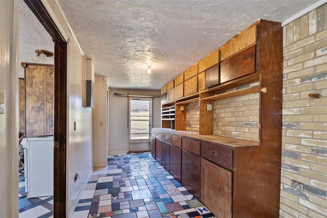 kitchen with butcher block counters and a textured ceiling