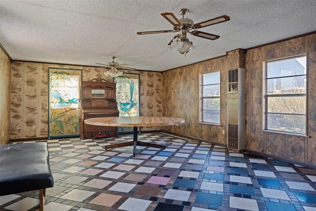 unfurnished dining area with a textured ceiling and a wealth of natural light