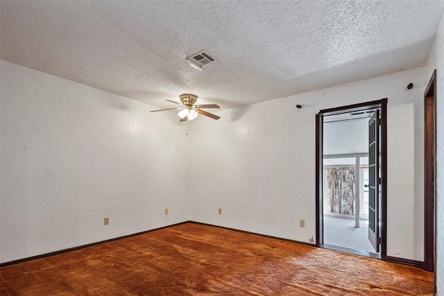 carpeted empty room with a textured ceiling and ceiling fan