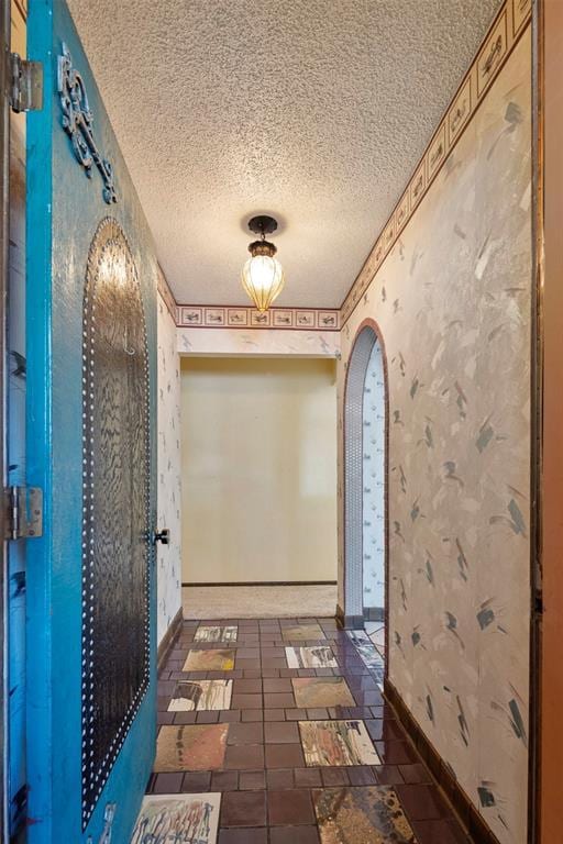 hallway featuring a textured ceiling