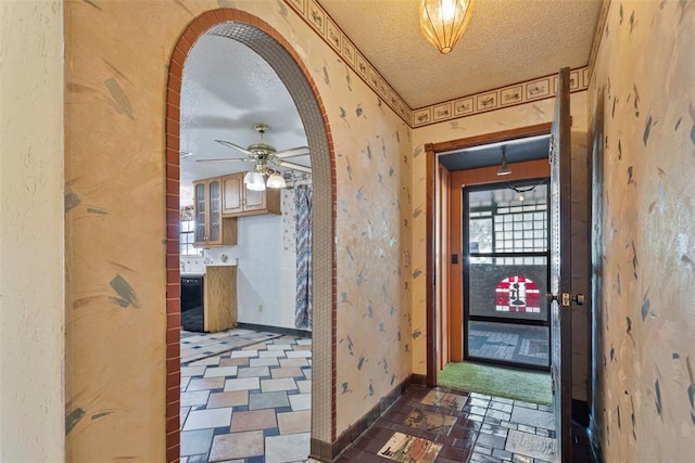 corridor featuring a textured ceiling