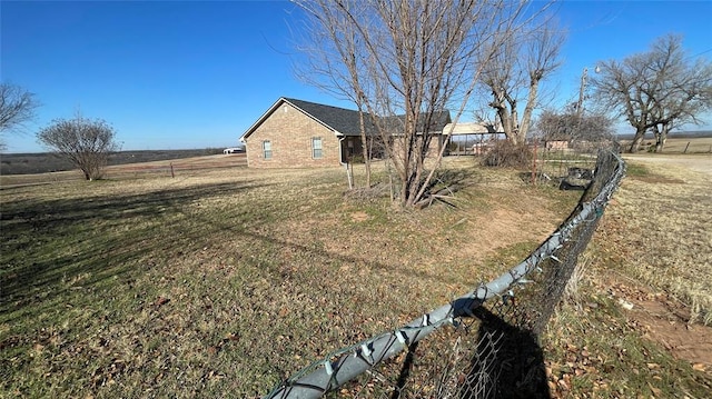 view of yard with a rural view