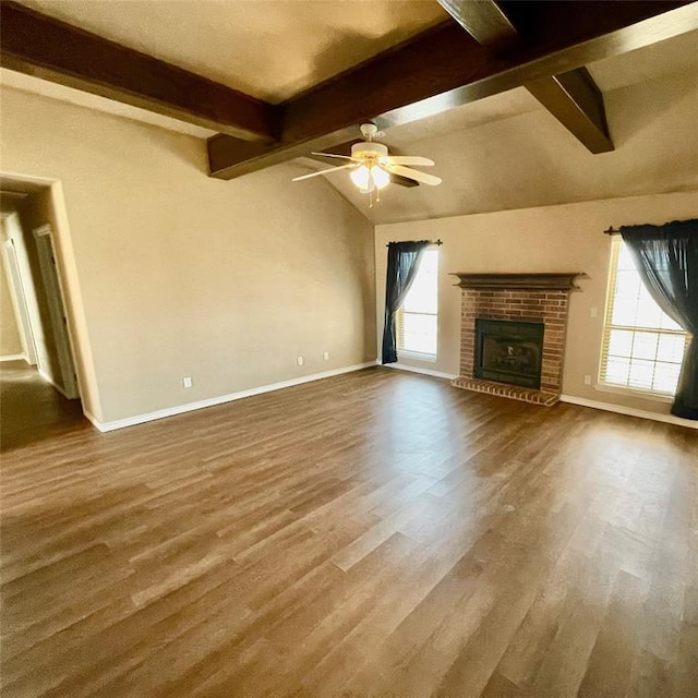 unfurnished living room with lofted ceiling with beams, ceiling fan, a fireplace, and wood-type flooring