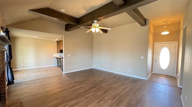 entryway with vaulted ceiling with beams, ceiling fan, light hardwood / wood-style flooring, and a brick fireplace